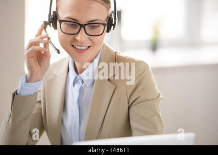 Call center operator answering call in office Stock Photo