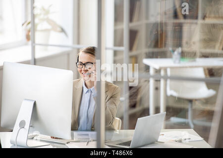 Positive customer service operator answering question of client Stock Photo