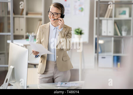 Successful business lady performing several tasks Stock Photo