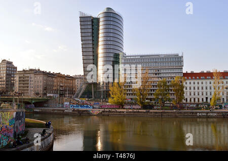 VIENNA, AUSTRIA - 31 MARCH 2019: The 75 meter tall Uniqa tower office block, completed in 2004, stands on the bank of the Donau Canal in Vienna, Austr Stock Photo
