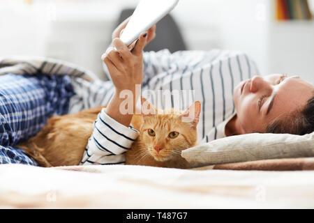 Cat Lying in Bed with Owner Stock Photo