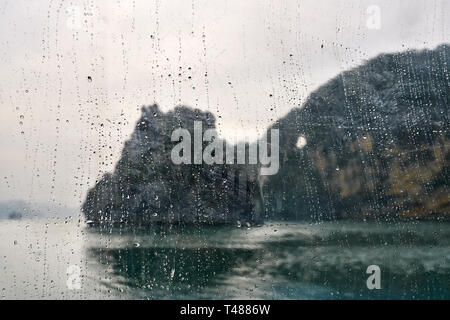 View through window at blurred landscape of sea bay of Halong Stock Photo