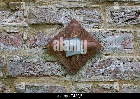 Metal support attached to brick wall Stock Photo