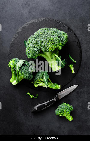 Fresh broccoli florets on black background, top view Stock Photo