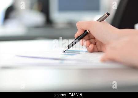 close up. blurred image of a business woman at her Desk. Stock Photo