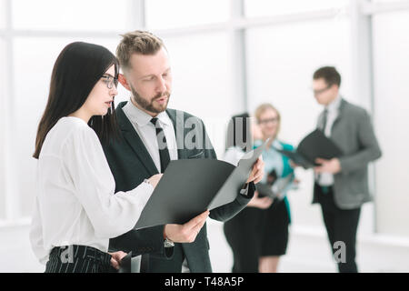 close up. business colleagues discuss business documents standing in the office Stock Photo