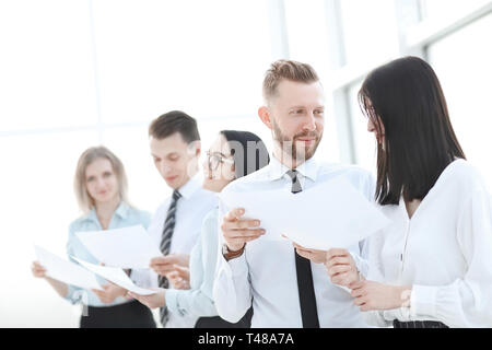 group of young employees discussing something in the office hallway. business and education Stock Photo