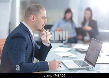 businessman using laptop to check financial data. Stock Photo