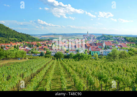 Beautiful panoramic landscape with rows of vineyards around picturesque Czech city Mikulov with dominant Mikulov Castle. Taken on a sunny day. Stock Photo