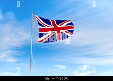 United Kingdom of Great Britain and Northern Ireland flag blowing in the wind over nice blue sky background Stock Photo