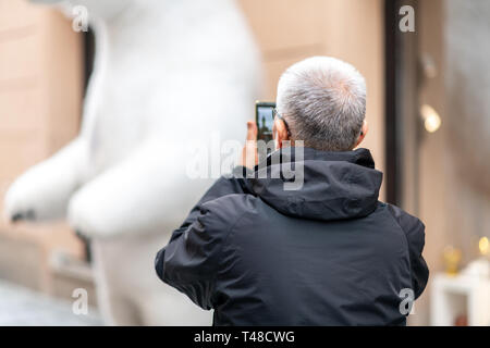 Old Asian Male tourist takes photos whilst sightseeing in Prague, Czech Republic - Easter Holidays April 2019 Stock Photo