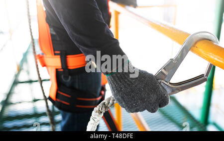 Construction worker wearing safety harness and safety line working on construction Stock Photo