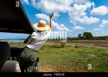 Woman enjoying the view from the safari truck Stock Photo