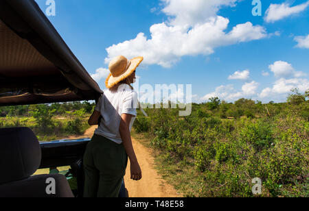 Woman enjoying the view from the safari truck Stock Photo