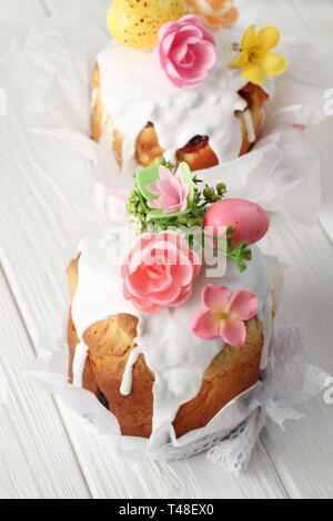 Easter cakes and painted eggs on white wooden background Stock Photo
