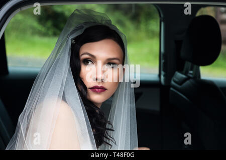 Bride in a wedding car Stock Photo