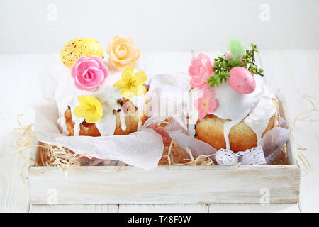 Easter cakes and painted eggs on white wooden background Stock Photo