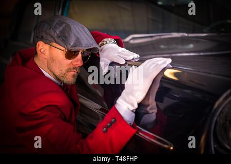 Vintage Classic Cars Collector. Caucasian Men Taking Close Look on the Vehicle Body. Automotive Theme. Stock Photo
