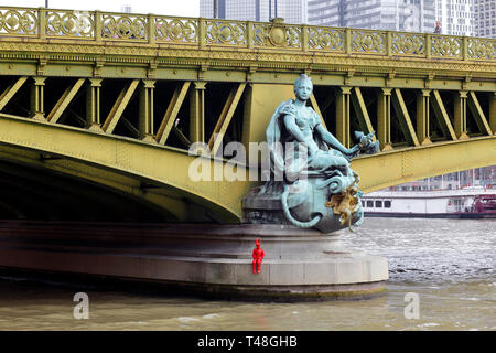 'Ville de Paris' one of four statues by Jean-Antoine Injalbert adorning Pont Mirabeau over the Paris Seine with an added red statue by James Colomina Stock Photo