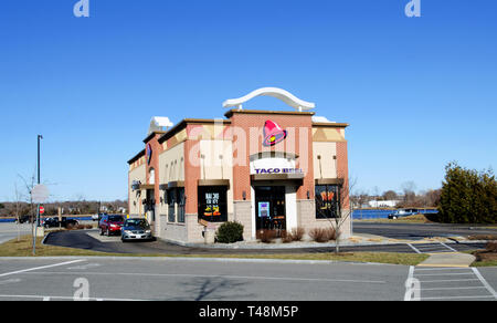 Taco Bell fast food restaurant exterior with drive-thru in New Bedford, MA USA with sunshine and clear blue sky Stock Photo