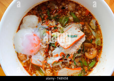 delicious spicy red pork noodles soup with soft-boiled egg Stock Photo