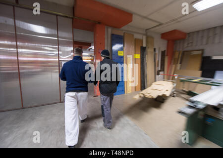 two young carpenters working together in big modern carpentry High quality wood concept Stock Photo