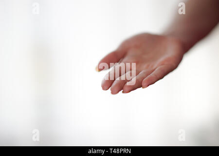female hand with palm up on a light background. Stock Photo