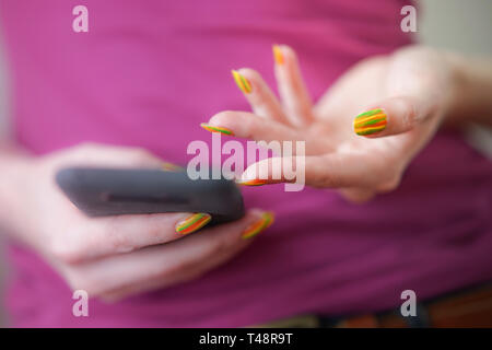 black smartphone in female hand with gestures. Stock Photo