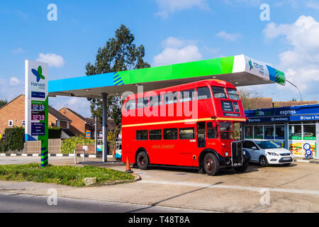 1949 AEC Regent lll double-decker shuttle bus of the Epping Ongar Railway refuelling at a Harvest Energy petrol station, North Weald, Essex, England Stock Photo