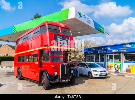 1949 AEC Regent lll double-decker shuttle bus of the Epping Ongar Railway refuelling at a Harvest Energy petrol station, North Weald, Essex, England Stock Photo