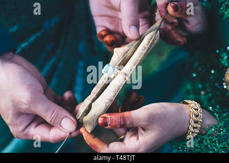 Married couple with traditional wedding dress showing their wedding rings. selective focus Stock Photo