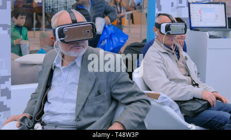 Senior people using virtual reality headset Stock Photo