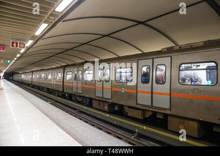 April 14, 2019. Greece, Athens. Metro station at the city center. Train in stationary with passengers, empty platform Stock Photo