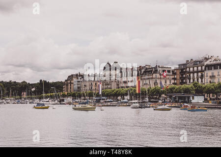 Geneva, Switzerland - July 1, 2017: View on lake and city Geneva, Switzerland, Europe. Summer landscape, sunshine weather, dramatic cloudy sky Stock Photo