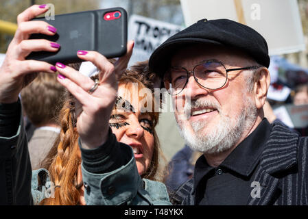 Actor Peter Egan at a stop trophy hunting and ivory trade protest rally, London, UK having a selfie with female with animal face paint Stock Photo