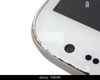 Used white cell phone close up. Camera detail and screen. Selective focus. Front view. Stock Photo