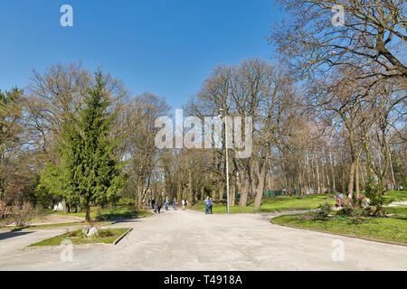 ROVNO, UKRAINE - APRIL 09, 2018: Unrecognized people walk in the Taras Shevchenko early spring park. Rovno or Rivne is a historic city in western Ukra Stock Photo