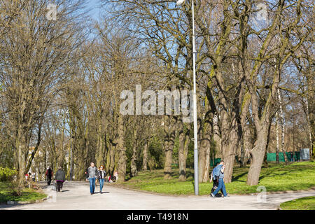 ROVNO, UKRAINE - APRIL 09, 2018: Unrecognized people walk in the Taras Shevchenko early spring park. Rovno or Rivne is a historic city in western Ukra Stock Photo