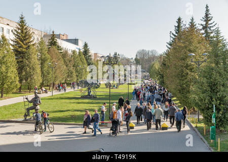 ROVNO, UKRAINE - APRIL 09, 2018: Unrecognized people walk in the Swan early spring park. Rovno or Rivne is a historic city in western Ukraine and the  Stock Photo