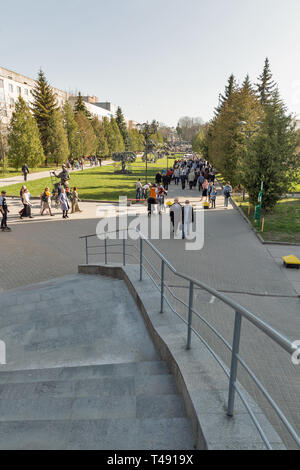 ROVNO, UKRAINE - APRIL 09, 2018: Unrecognized people walk in the Swan early spring park. Rovno or Rivne is a historic city in western Ukraine and the  Stock Photo