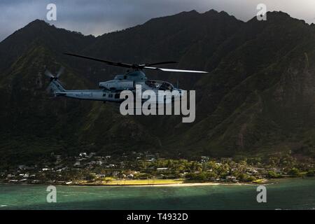 A U.S. Marine Corps AH-1Z Viper attack helicopter with Marine Light Attack Helicopter Squadron 367 conducts a memorial flight April 12, 2019 over Oahu, Hawaii. The flight was in honor of Marine Viper pilots Capt. Brannon and Maj. Matthew M. Wiegand, who were killed in a crash on March 30. Stock Photo