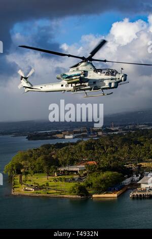 A U.S. Marine Corps AH-1Z Viper attack helicopter with Marine Light Attack Helicopter Squadron 367 conducts a memorial flight April 12, 2019 over Oahu, Hawaii. The flight was in honor of Marine Viper pilots Capt. Brannon and Maj. Matthew M. Wiegand, who were killed in a crash on March 30. Stock Photo