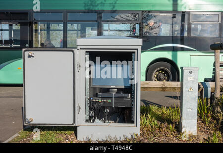 A roadside cabinet reveals a computer complete with monitor inside at Mereoak Park and Ride bus station in Reading, UK Stock Photo