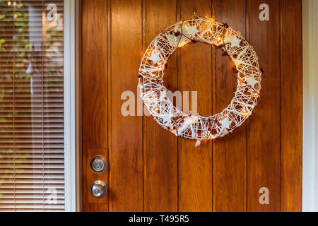 Australian summer Christmas Wreath hanging on front door. Stock Photo