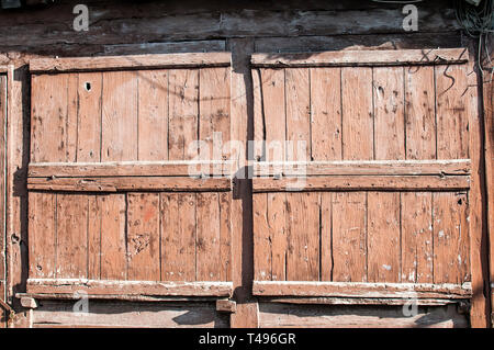 Old weathered grunge closed wooden boards window shutters of vintage country house Stock Photo