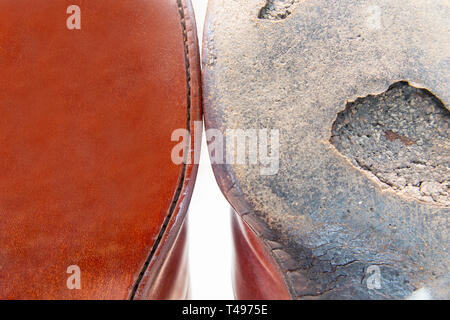 A conceptual picture of an old sole of a shoe and a brand new one - new versus old Stock Photo