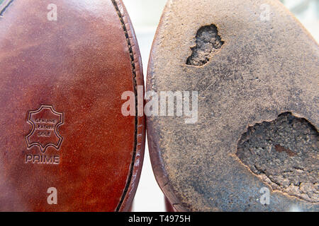 A conceptual picture of an old sole of a shoe and a brand new one - new versus old Stock Photo