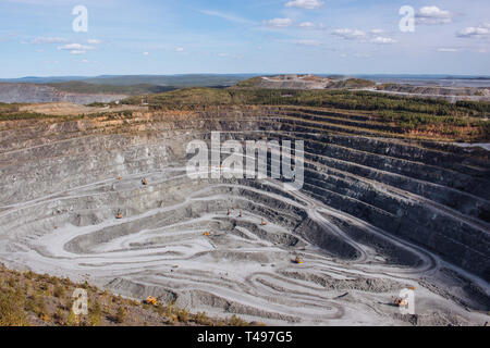 Aerial view industrial of opencast mining quarry with lots of machinery at work - view from above. Extraction of lime, chalk, calx, caol Stock Photo