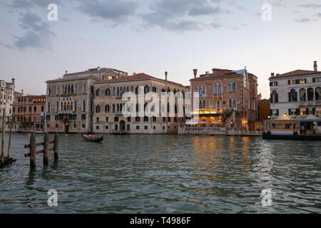 Venice, Italy - June 30, 2018: Panoramic view of Venice grand canal view with historical buildings and gondola. Landscape of summer evening day and co Stock Photo