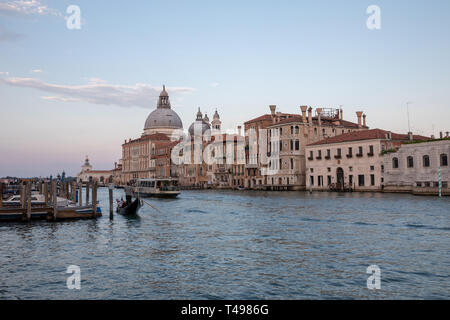 Venice, Italy - June 30, 2018: Panoramic view of Venice grand canal view with historical buildings, gondola and boats, away of Basilica Salute. Landsc Stock Photo